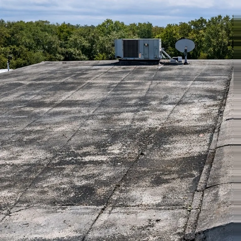 Aged commercial flat roof before restoration